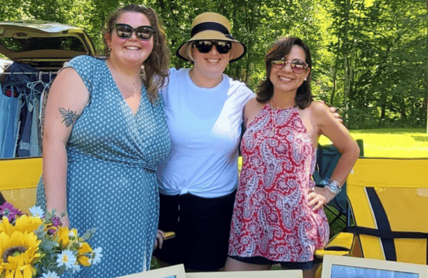 people behind table at hollergirl music festival