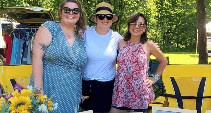 people behind table at hollergirl music festival