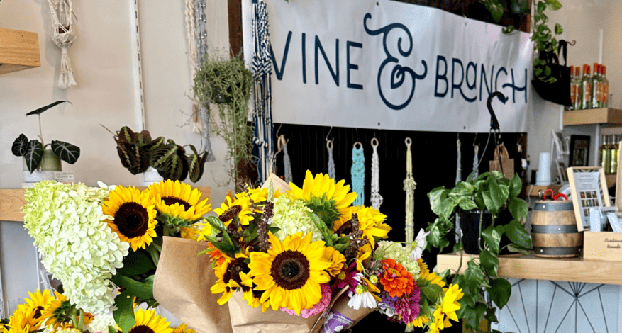 vine and branch sign with flowers