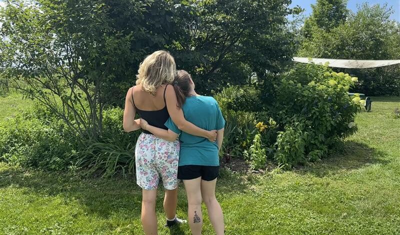 two people embracing outside