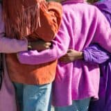 four people embracing