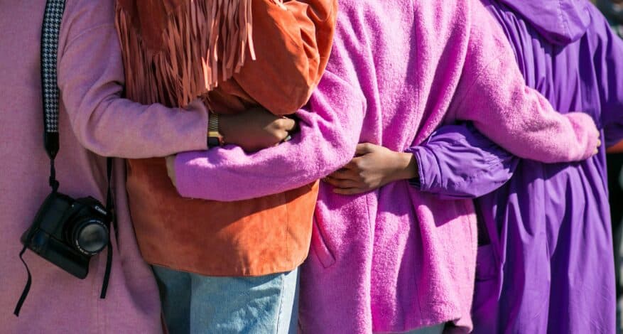 four people embracing