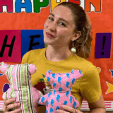 person holding bears in front of bulletin board