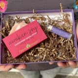 person holding gift box of soap and lip balm