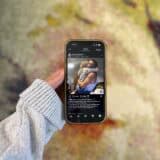 holding up phone showing instagram post