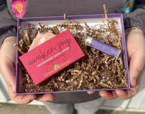 person holding gift box of soap and lip balm