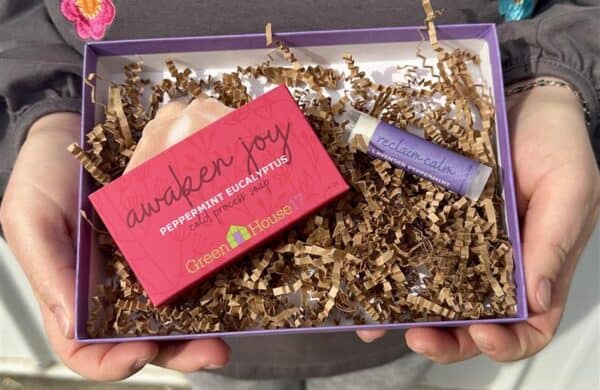 person holding gift box of soap and lip balm