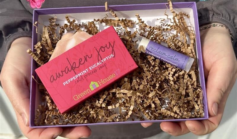 person holding gift box of soap and lip balm